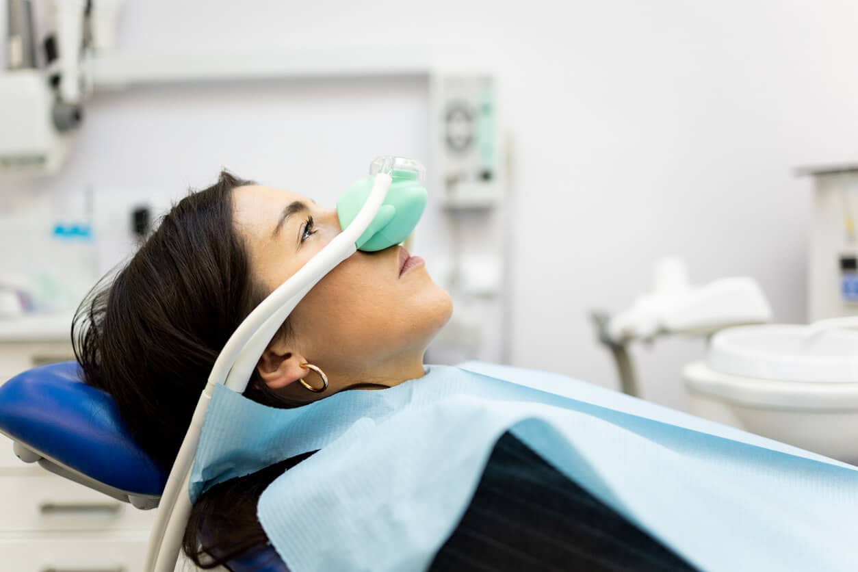 Patient relaxing with a nitrous oxide nasal mask during sedation dentistry